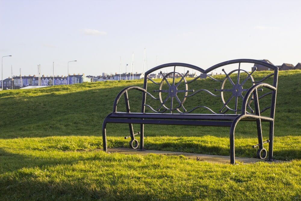 A Bench is Sitting in the Middle of a Grassy Field — Hastings Valley Powdercoaters in Harrington, NSW
