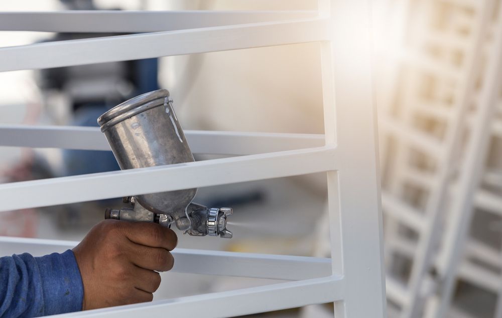 A Close Up Photo of a Person Coating Powder on a Window Frame — Hastings Valley Powdercoaters in South West Rocks, NSW