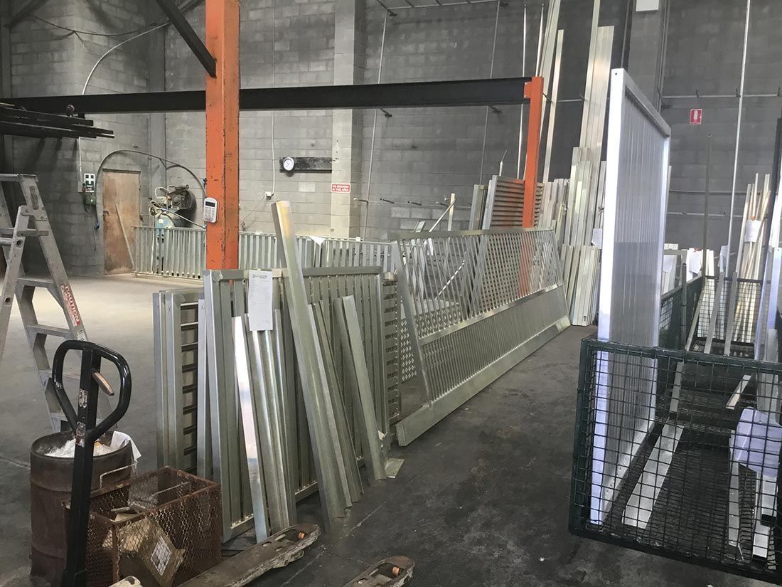 A Warehouse Filled With Lots of Metal Pieces and a Pallet Truck — Hastings Valley Powdercoaters in South West Rocks, NSW