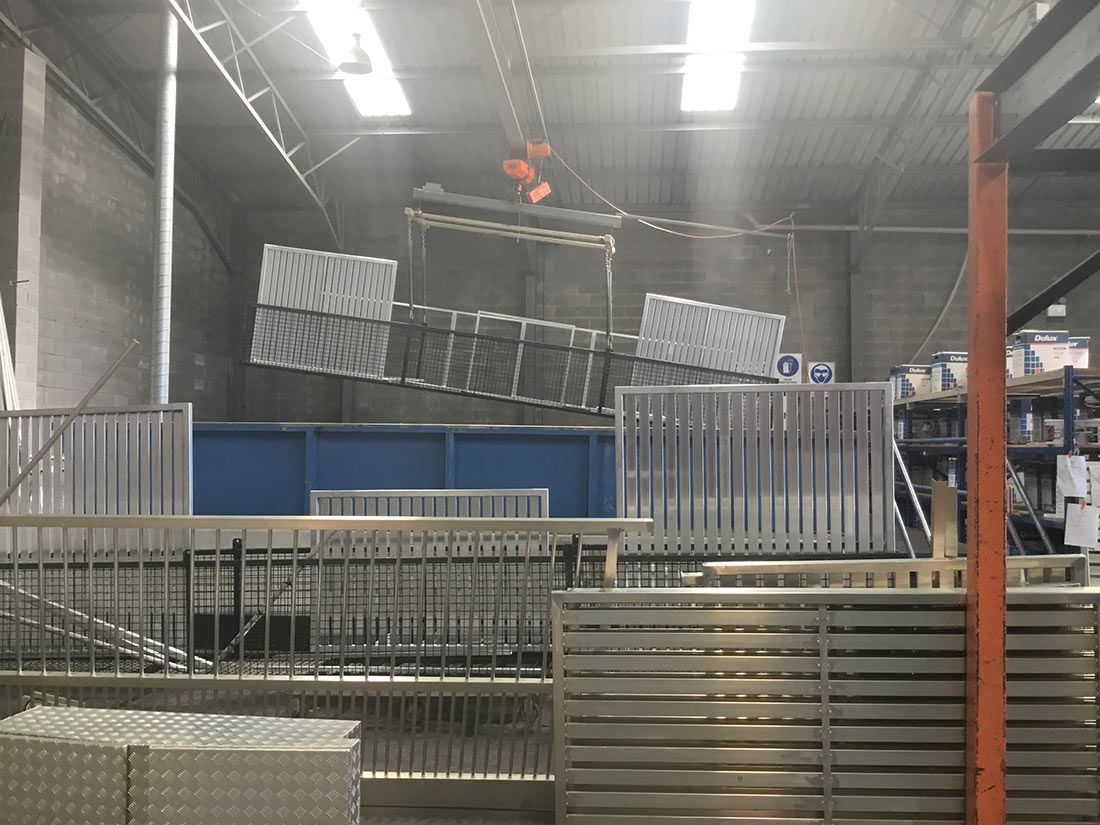 A Warehouse With a Lot of Boxes Hanging From the Ceiling — Hastings Valley Powdercoaters in Taree, NSW