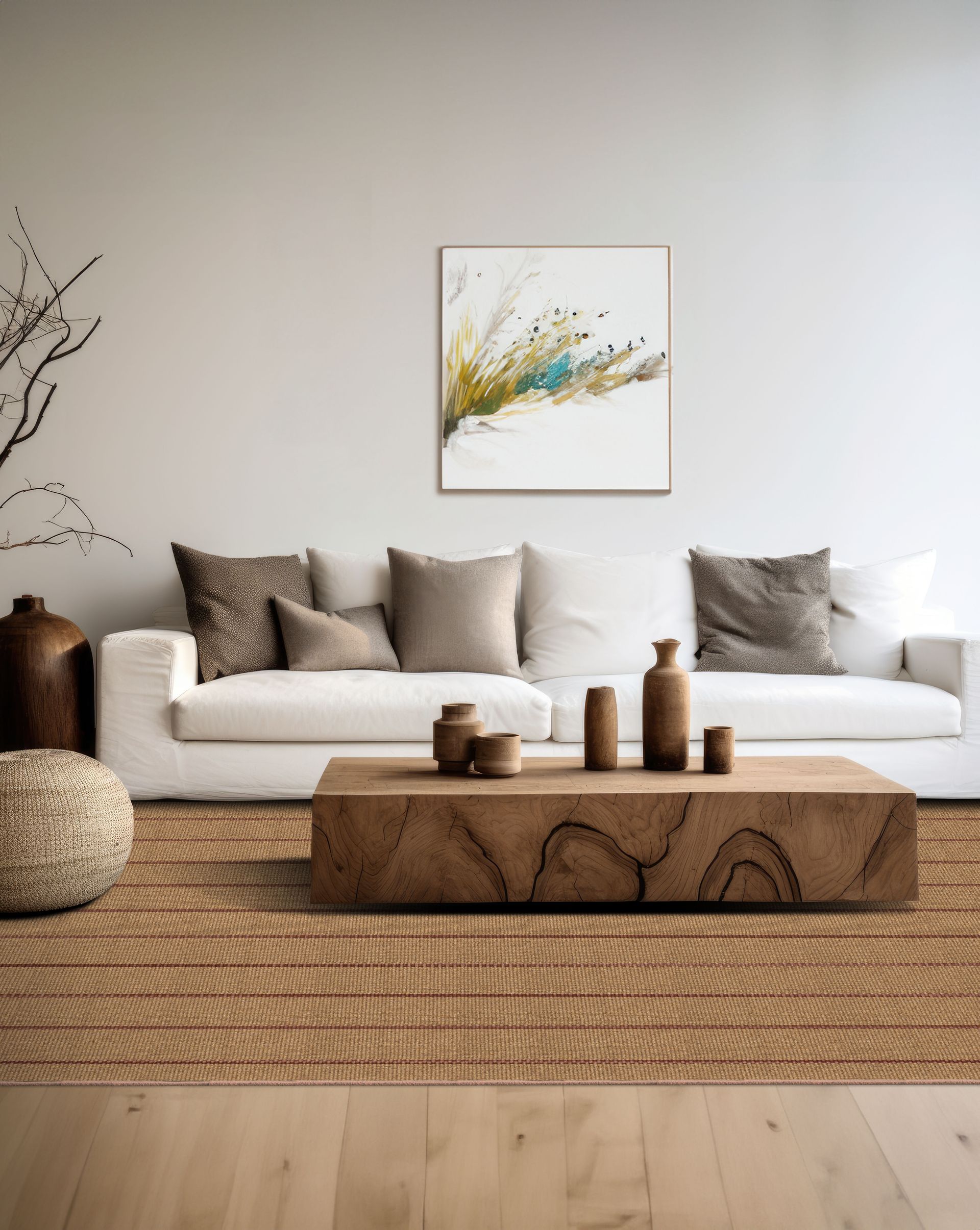 Living room with white sofa, wooden coffee table, and abstract art; neutral tones.