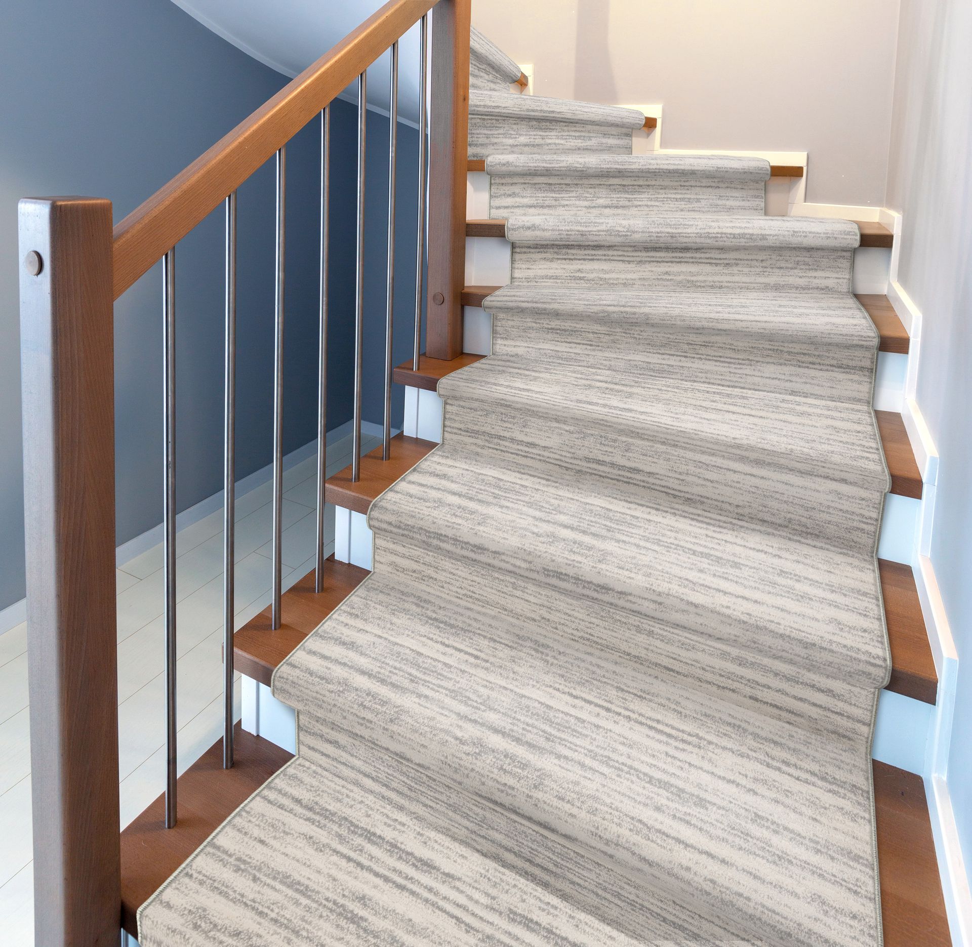 Staircase with light gray carpet and wooden railing. Interior setting, well-lit.