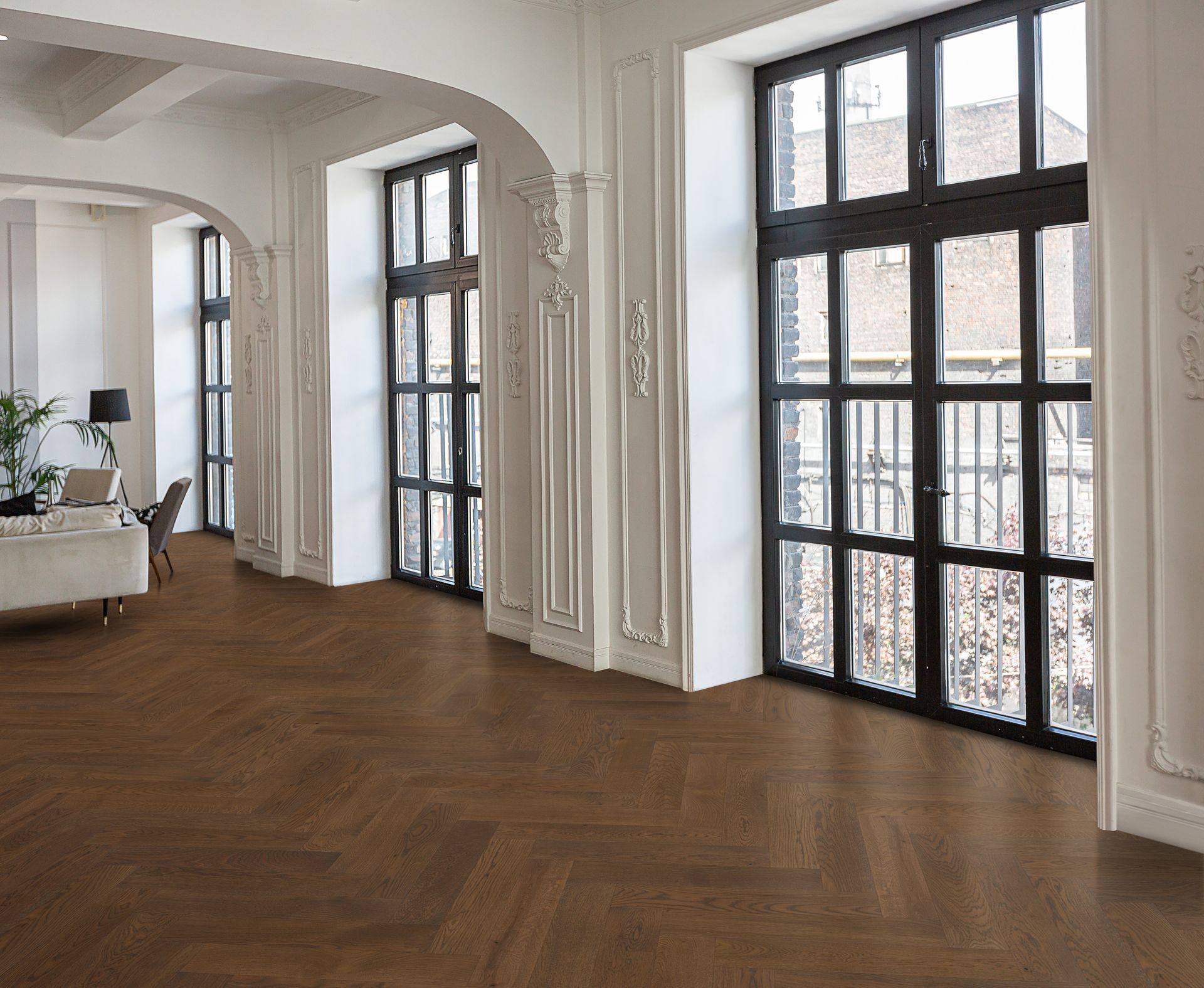 Wooden floor in room with large windows, white walls, and decorative molding.