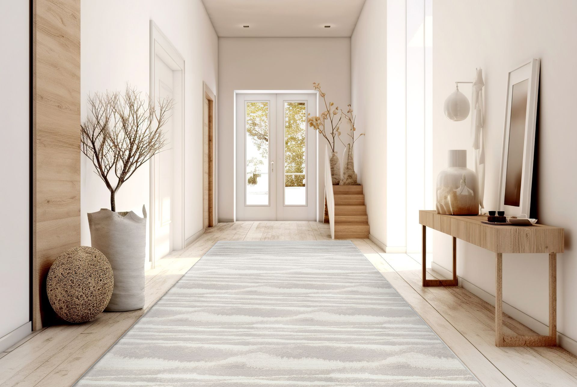 Hallway with light wood floors, rug, and console table. Features a double door entrance with sunlight.