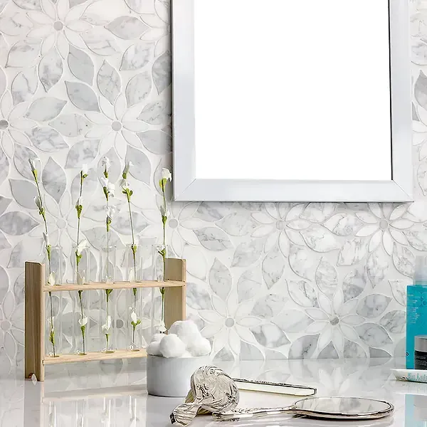 Bathroom counter with floral tile, mirror, test tube vase, cotton balls, keys, and toiletries.