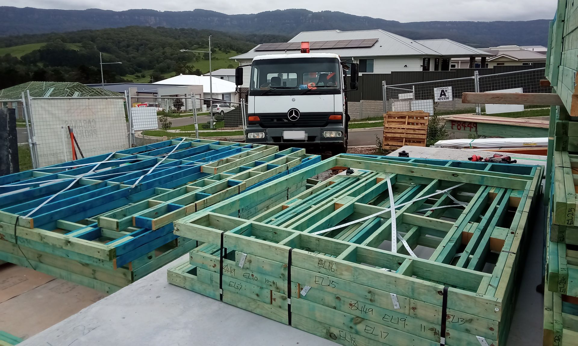 Prefabricated timber wall frames delivered to a residential construction in Calderwood, beneath the Illawarra escarpment.