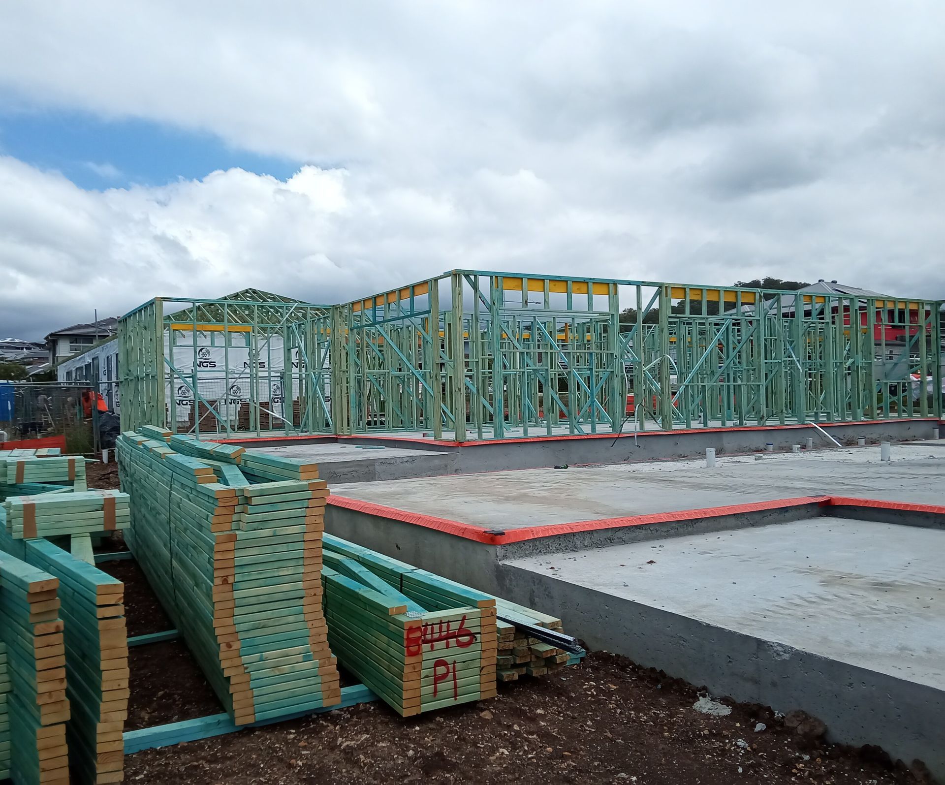 Roof trusses being delivered via crane truck showing wall frames