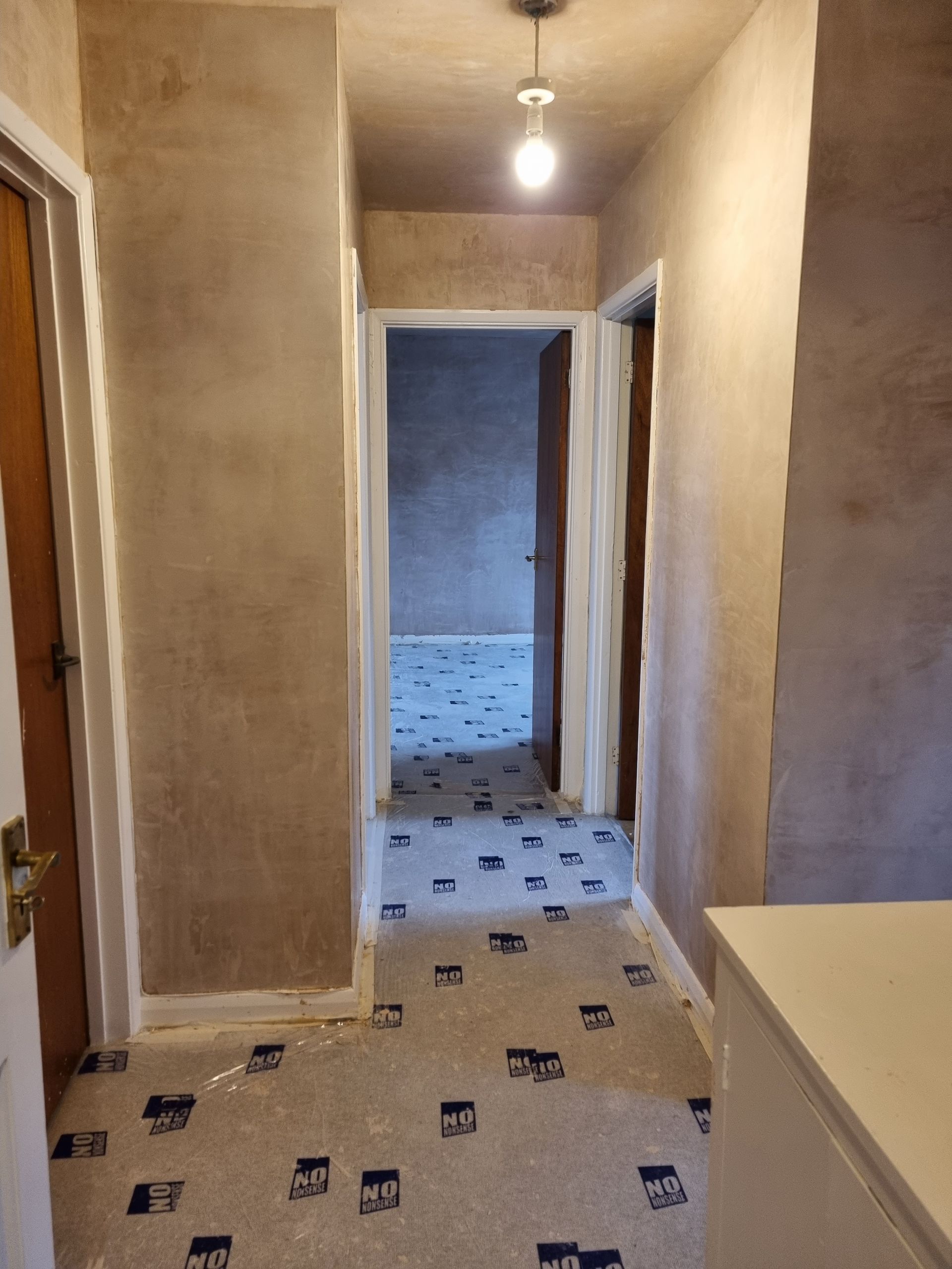 Hallway plastering with floor protection, ceiling artex skimmed over