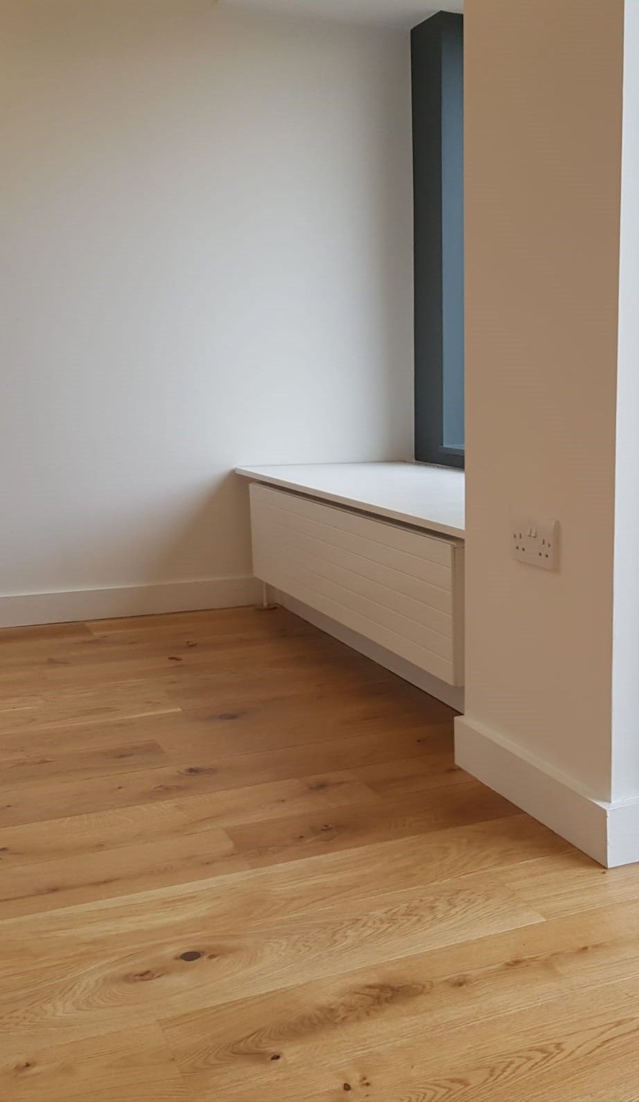 Bespoke carpentry work, window seat with hidden storage and engineered oak flooring