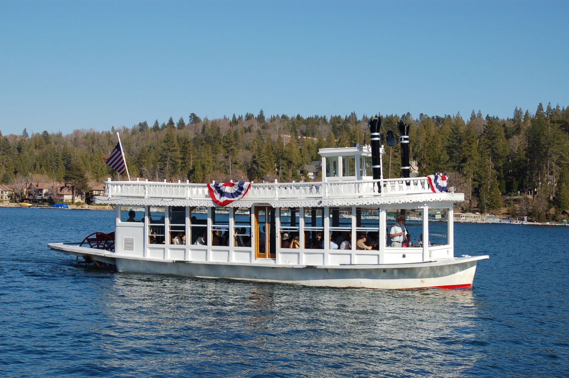 a large white boat is floating on a lake