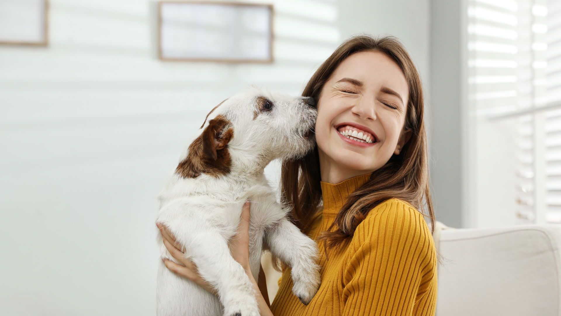 woman kissing by a dog