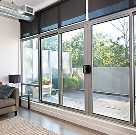 A living room with a lot of windows and a couch.