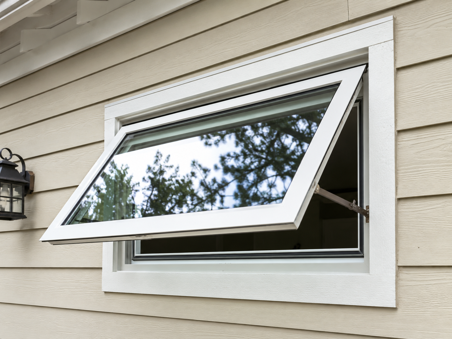 A white bay window with stained glass on a house