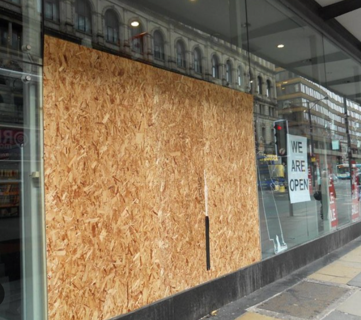 A store front with a sign that says we are open