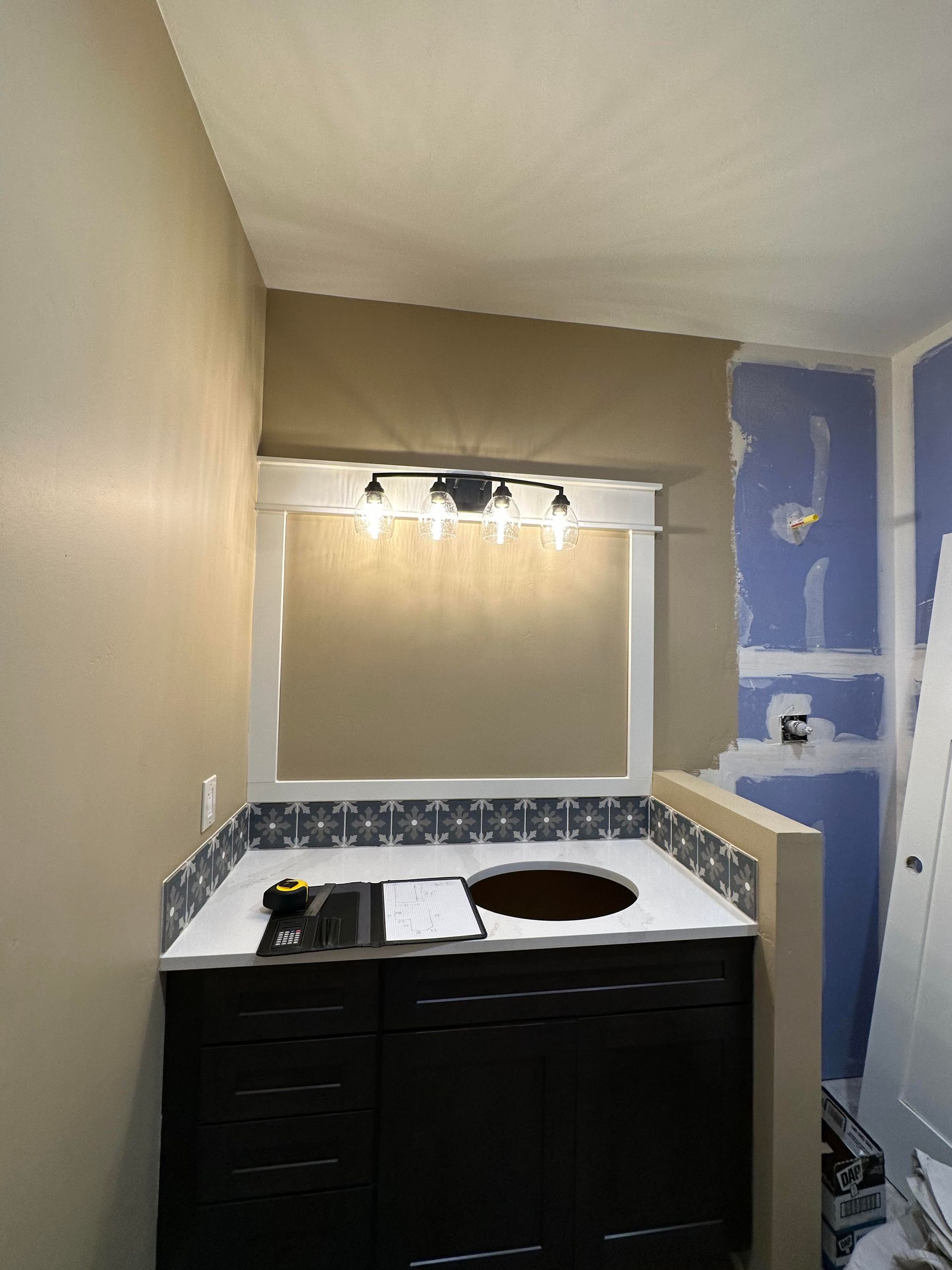 A bathroom with a sink and a mirror in it