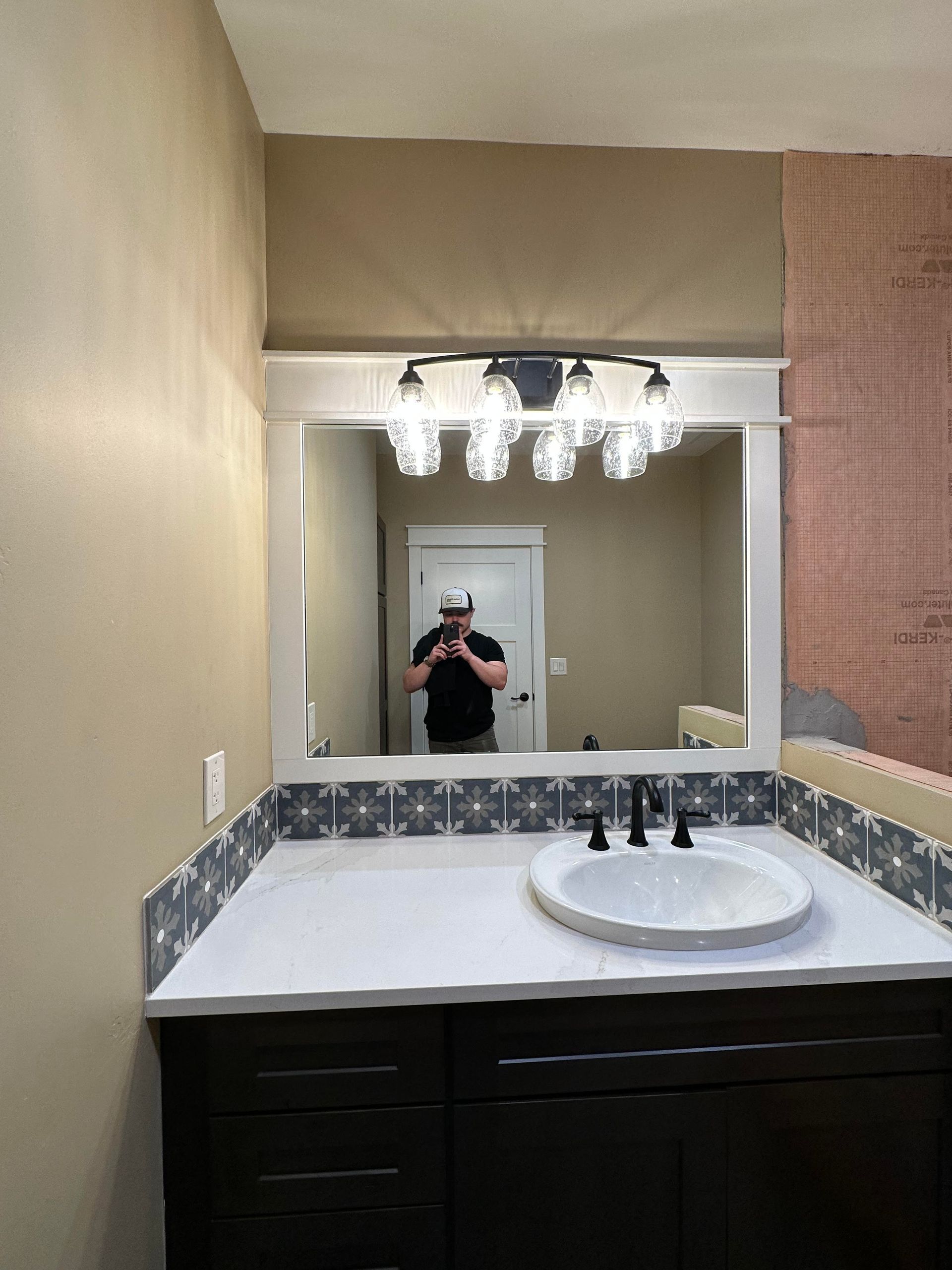 A man is taking a picture of himself in a bathroom mirror.