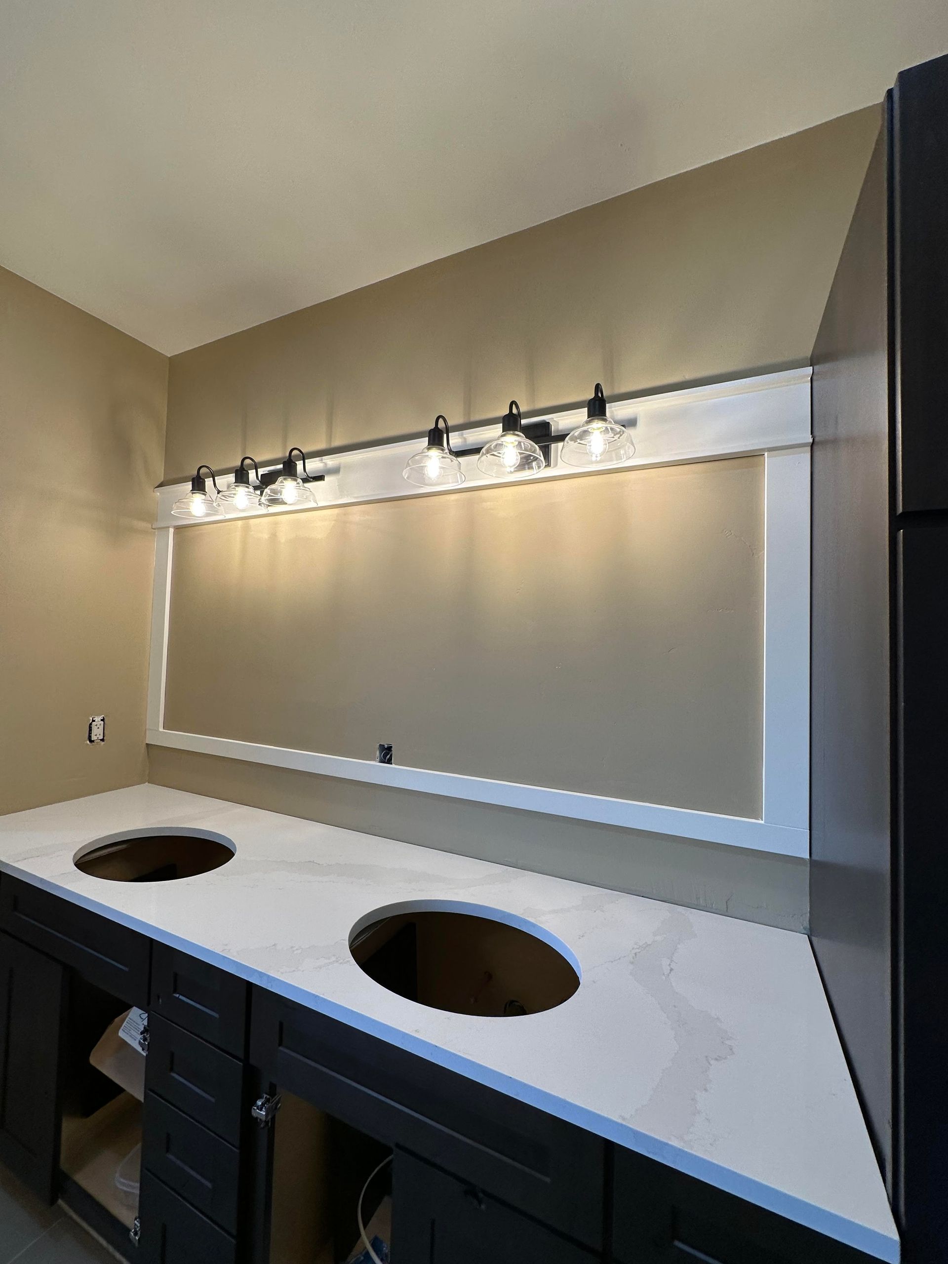 A bathroom with two sinks and a vanity.