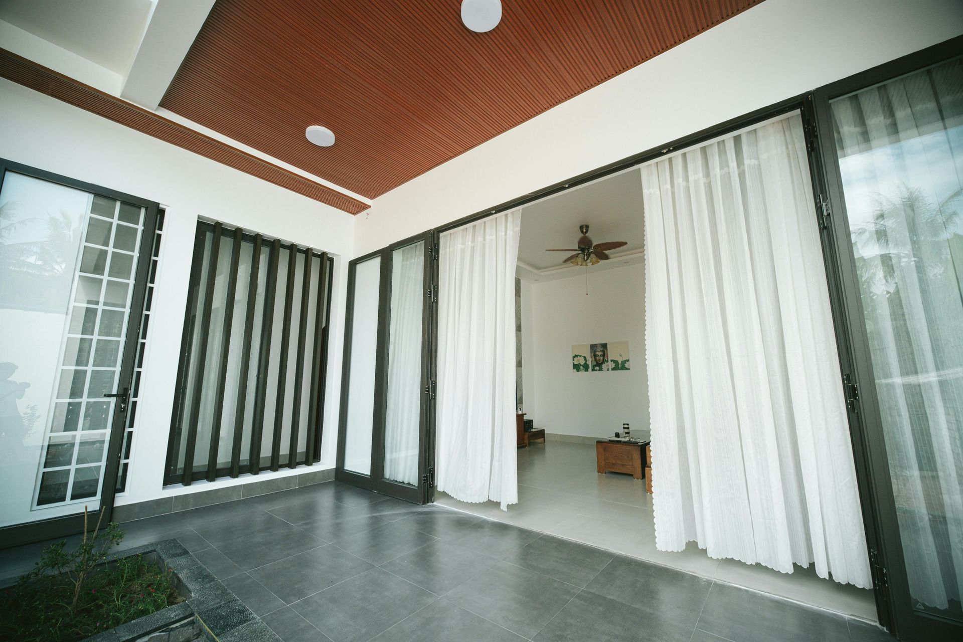 A living room with sliding glass doors leading to a patio.