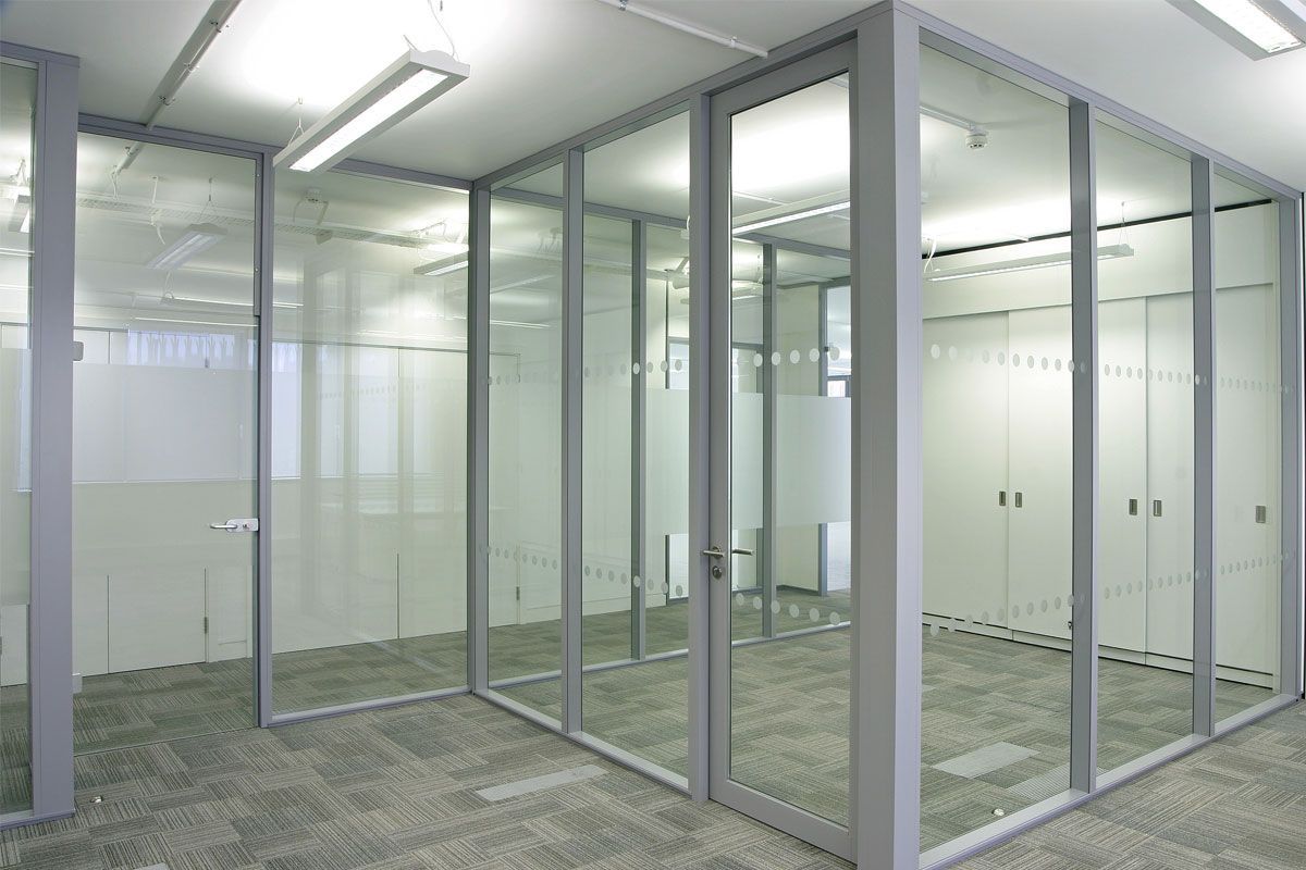 A room with a lot of glass walls and doors.