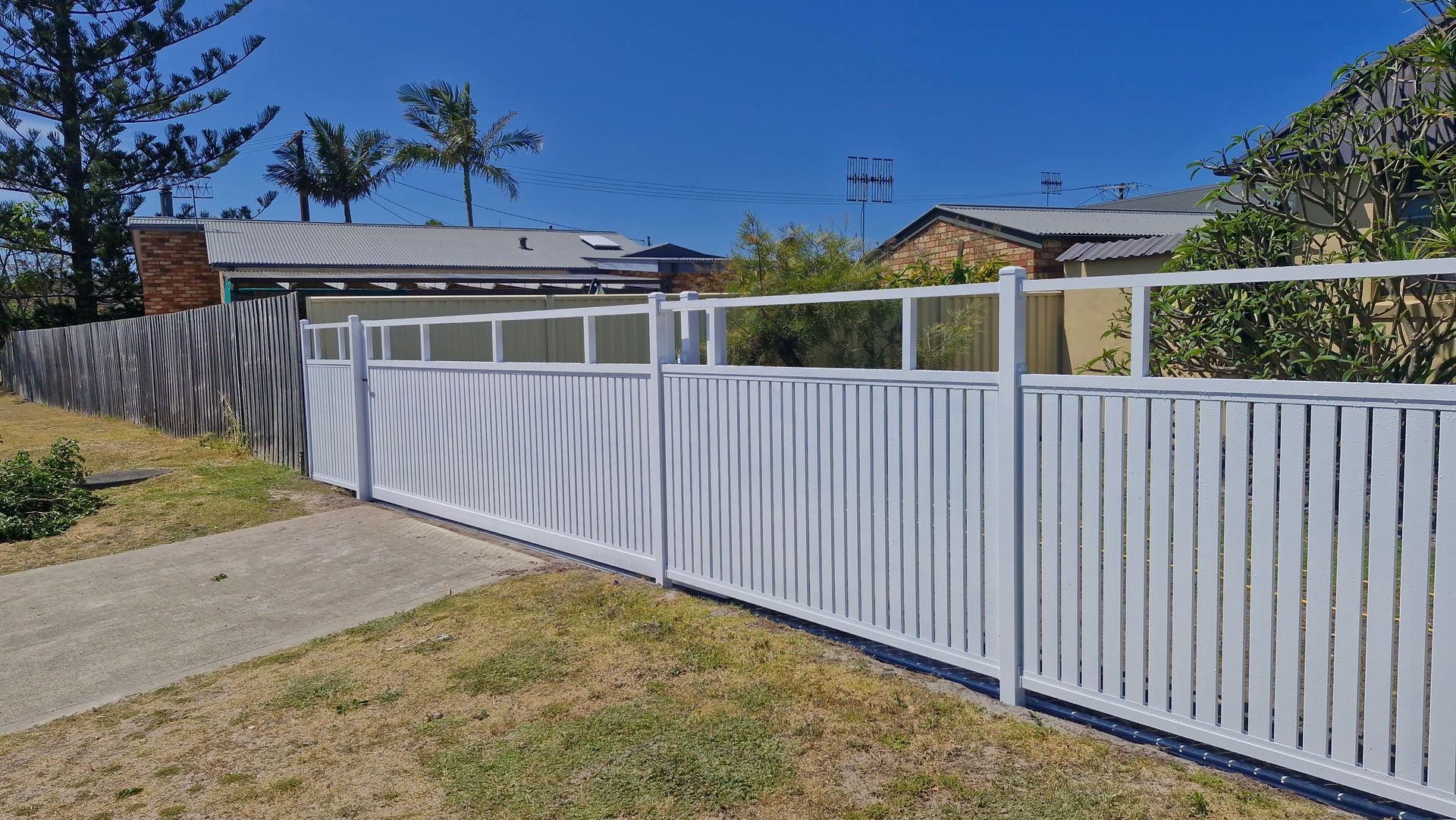 Black Metal Gate, Open, With Vertical Bars, Leading to a Driveway — Strike Fencing & Gates In Tuggerah, NSW