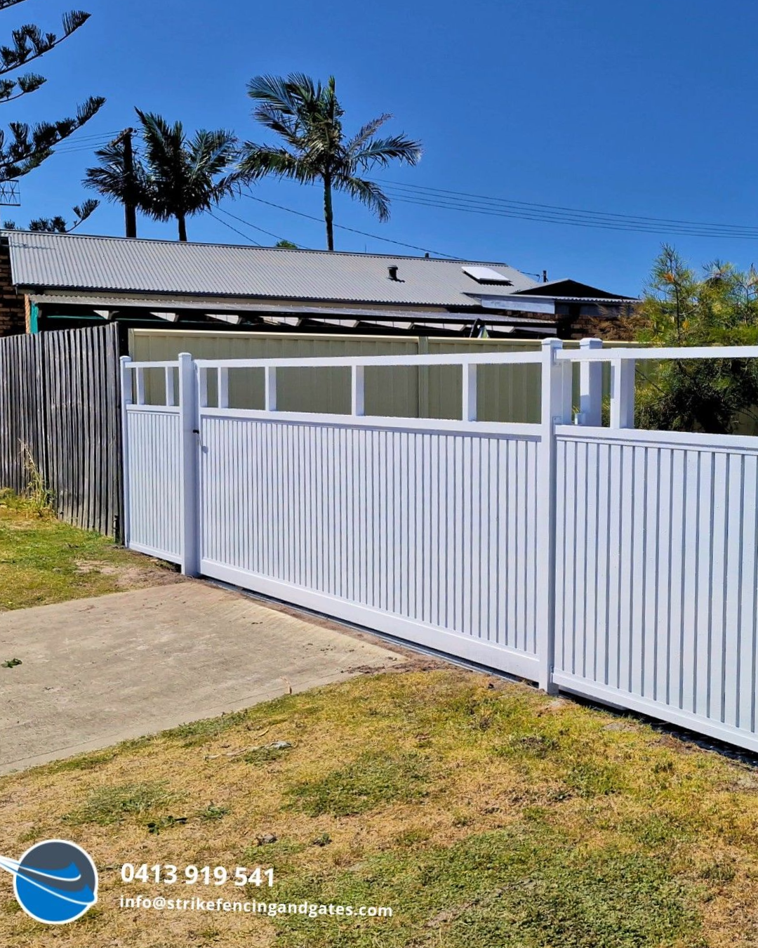 White aluminium slat fencing on a Central Coast home with a metal roof and palm trees.