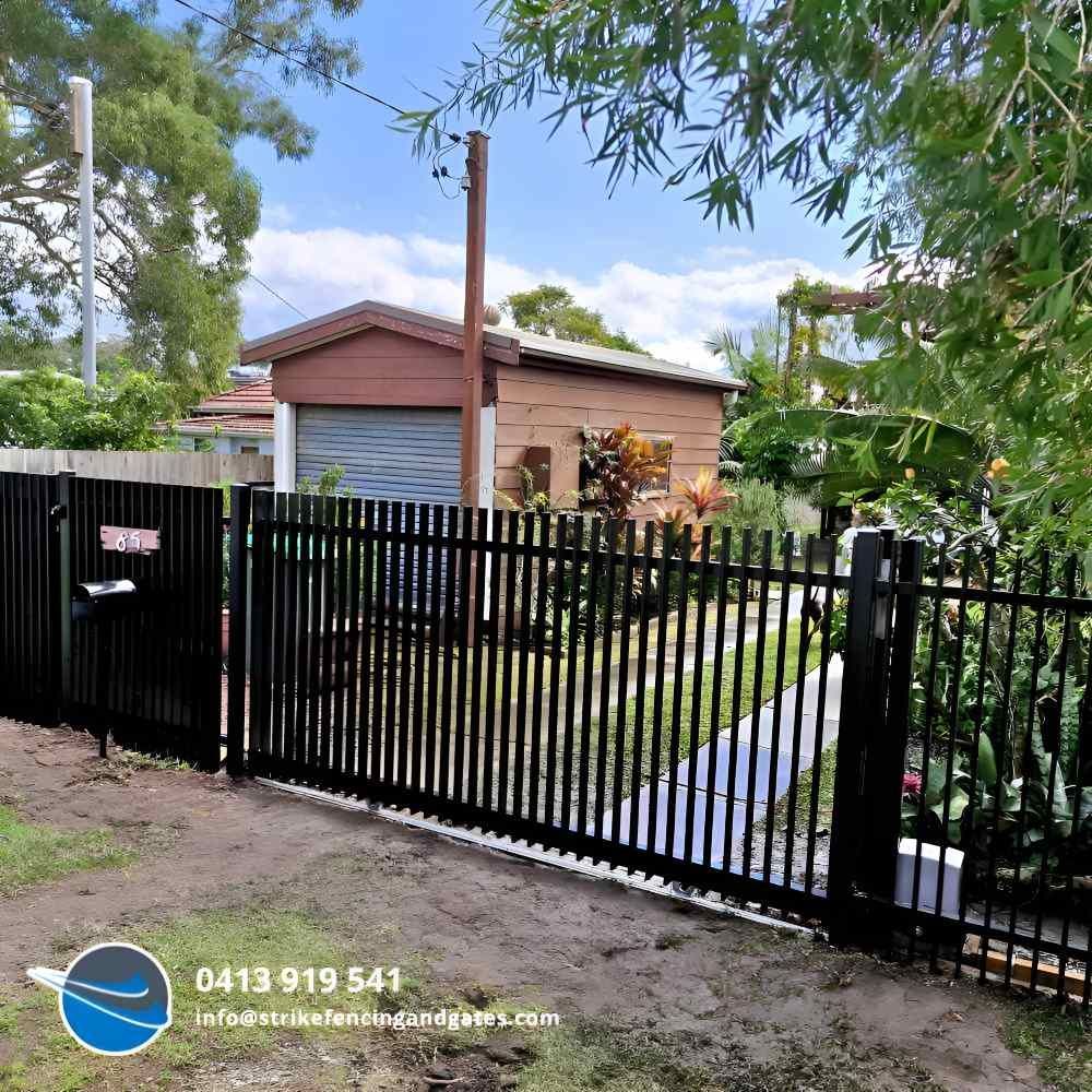 Black Metal Gate and Fence in Front of a House — Strike Fencing & Gates In Bateau Bay, NSW