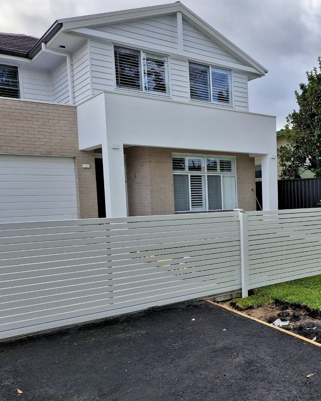 House Behind A White Slatted Fence