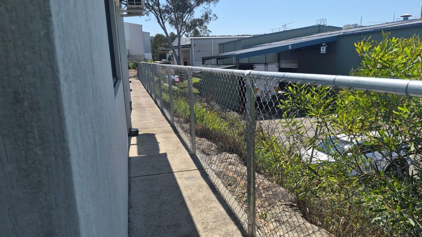Narrow Outdoor Walkway Beside a Building — Strike Fencing & Gates In Gosford, NSW