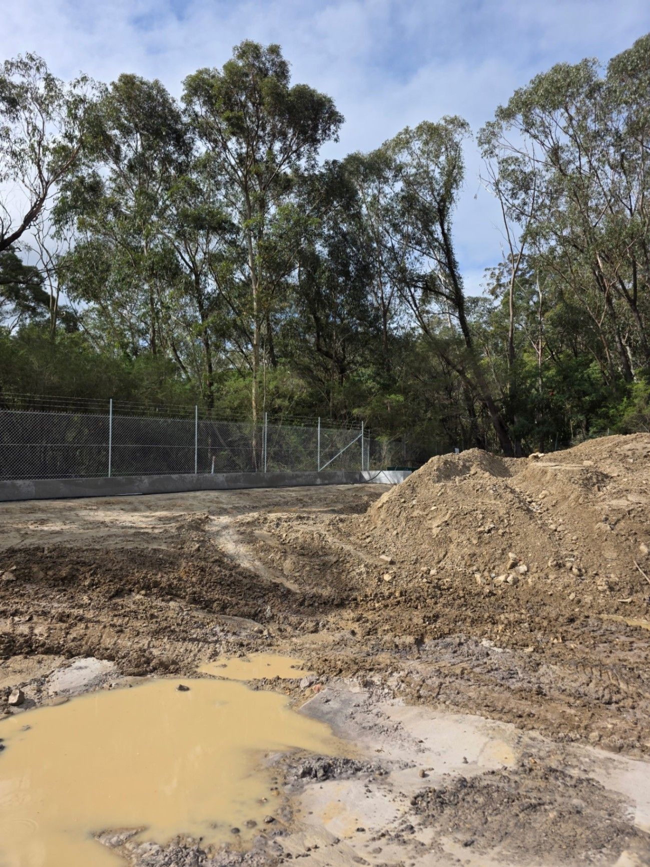 Mud Puddles and Dirt Piles at A Construction Site Beside — Strike Fencing & Gates In Gosford, NSW