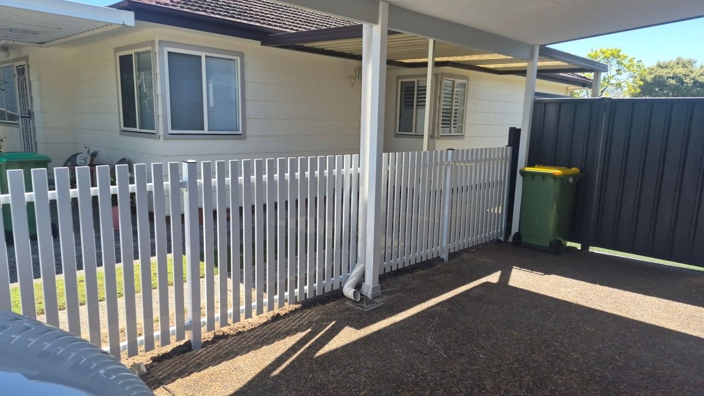 Small House Exterior with White Picket Fence, Driveway — Strike Fencing & Gates In Umina, NSW