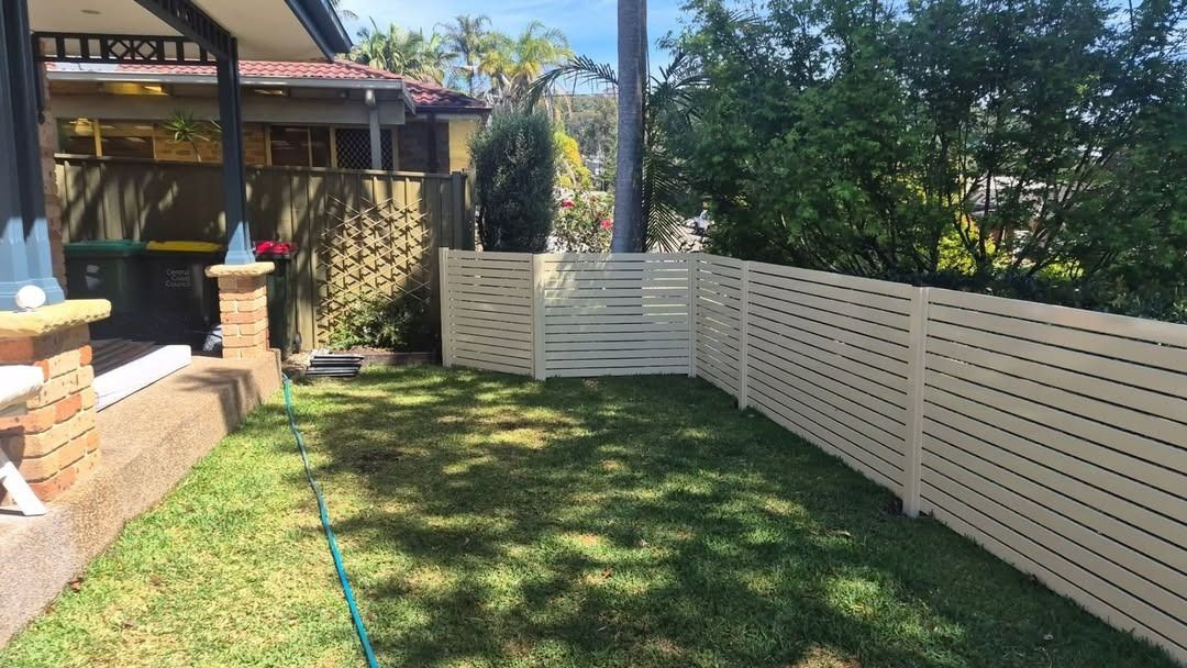 Backyard Lawn with White Fence, Patio, and A Garden Hose — Strike Fencing & Gates In Terrigal, NSW