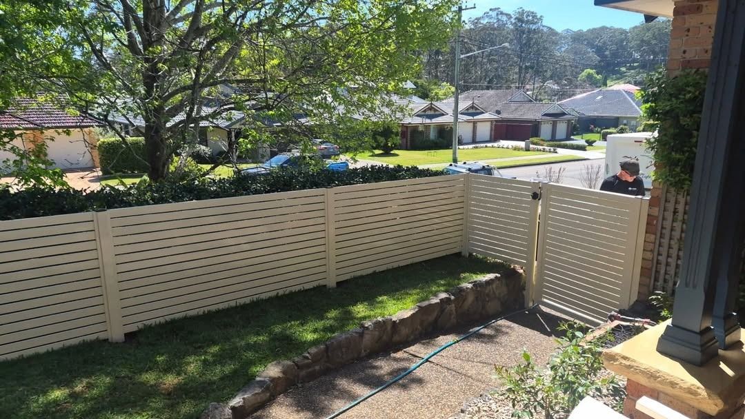 Backyard with White Privacy Fence, Stone Retaining Wall — Strike Fencing & Gates In Terrigal, NSW