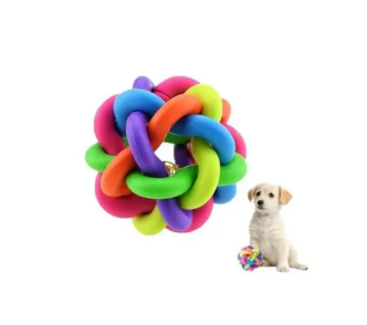 Un juguete para perros en forma de pelota anudada multicolor junto a un pequeño cachorro.
