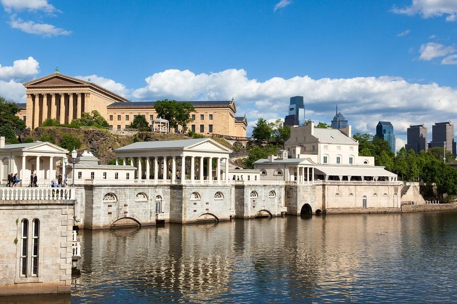 A large building is sitting next to a body of water.