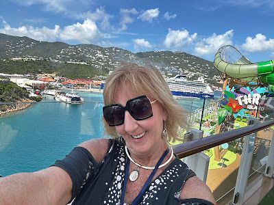 A woman is taking a selfie on a cruise ship.