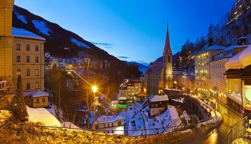 A snowy town with a church in the middle of it