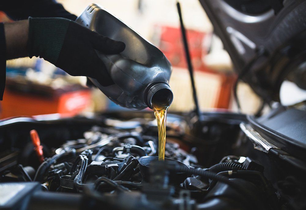 Auto Mechanic Pouring Oil to Car Engine | Sparks, NV | Bimmer Experts Reno