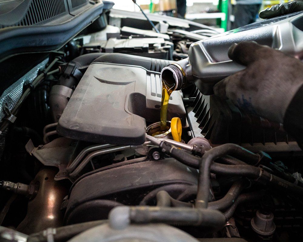 Auto Mechanic Changing Car Engine Oil | Sparks, NV | Bimmer Experts Reno