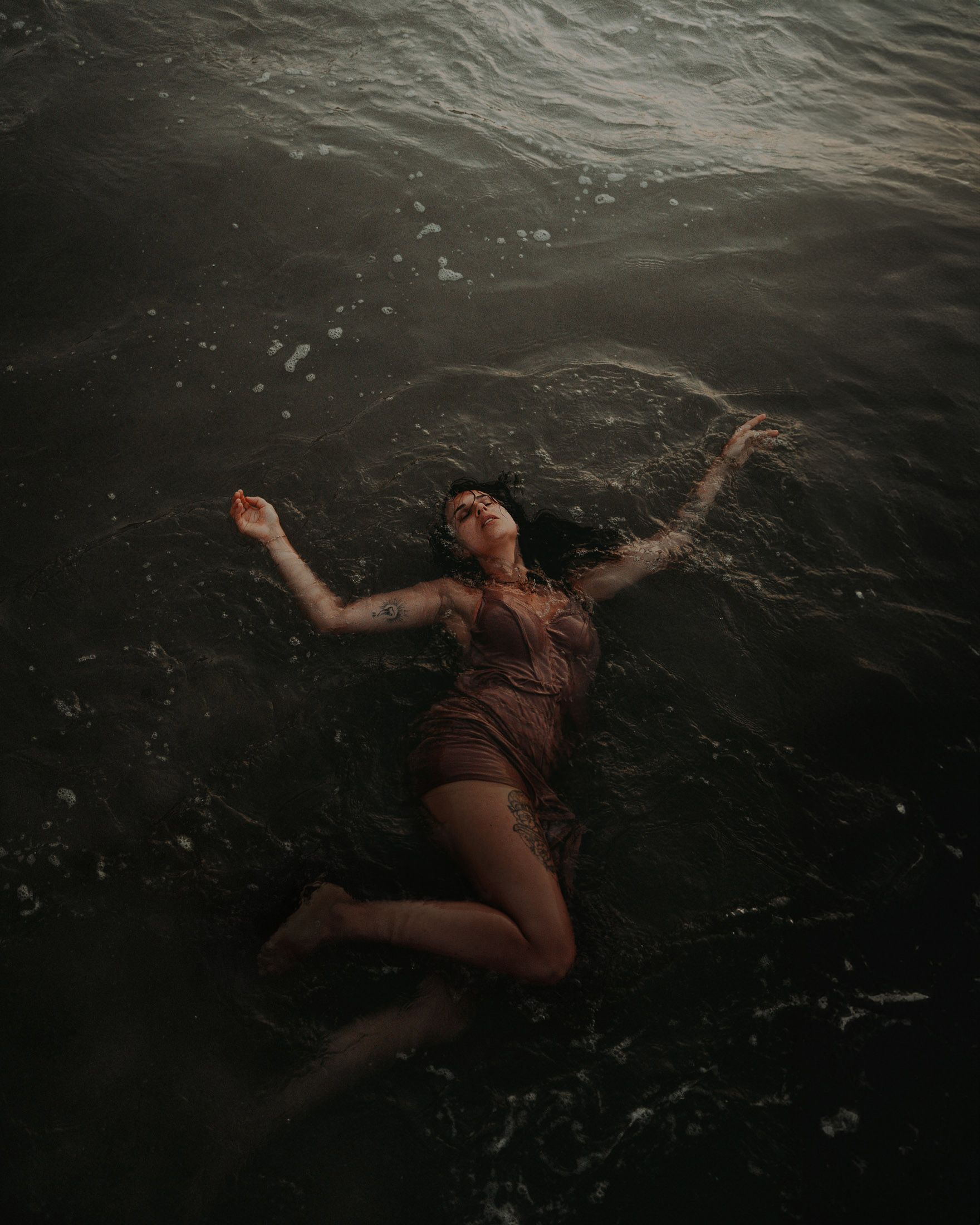 Eine Frau treibt auf dem Rücken im Wasser.