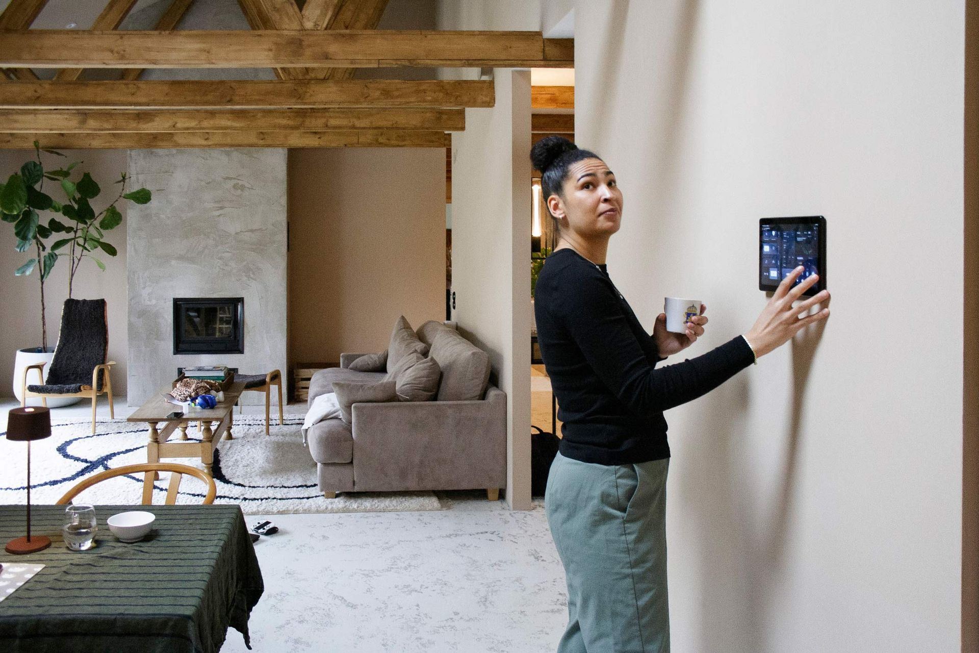 A woman adjusting the smart heating system