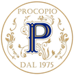 Logo Procopio in oro e blu, con monogramma floreale ornato e la scritta “DAL 1975” in un logo circolare