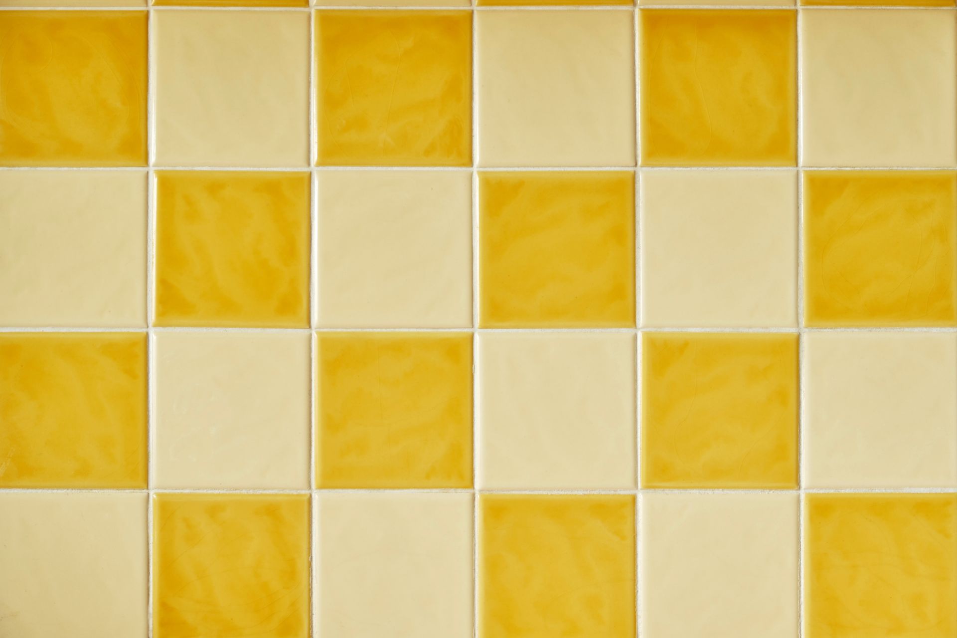Yellow and cream checkered tile wall pattern