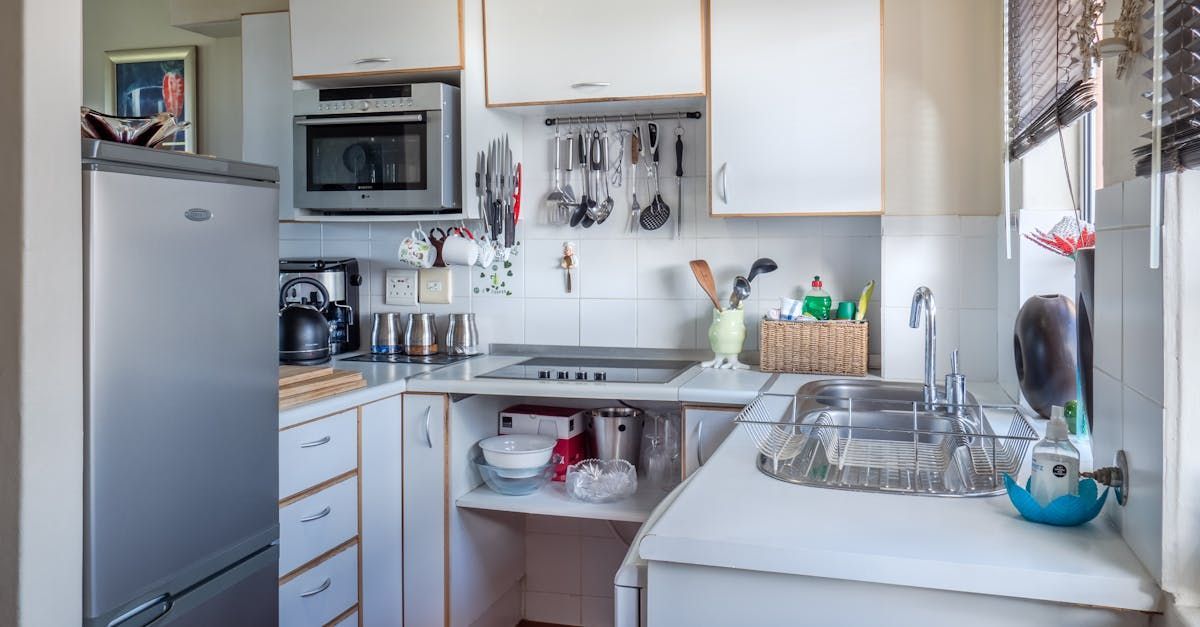 Plumber in Dereham Road for small kitchen with white cabinets.