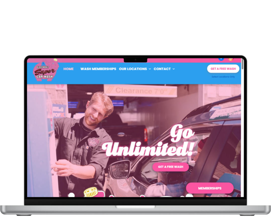 VISIT WEBSITE Laptop displaying a colorful website with “Go Unlimited!” over a man leaning beside a car in a garage.