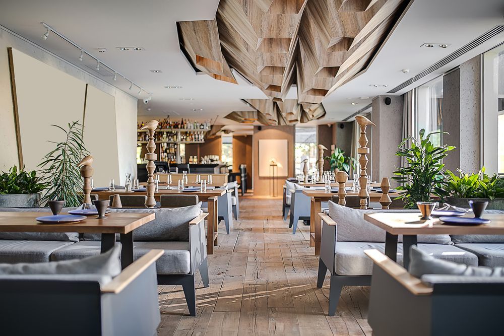 A restaurant with tables and chairs and a wooden ceiling