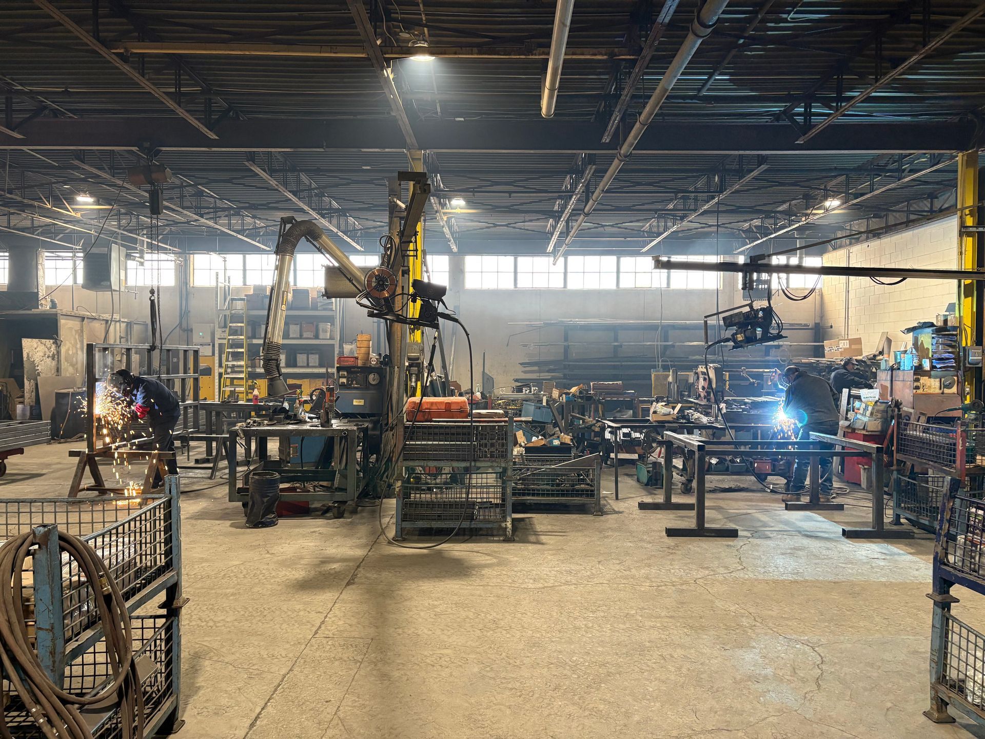 A factory with a lot of machinery and people working in it.