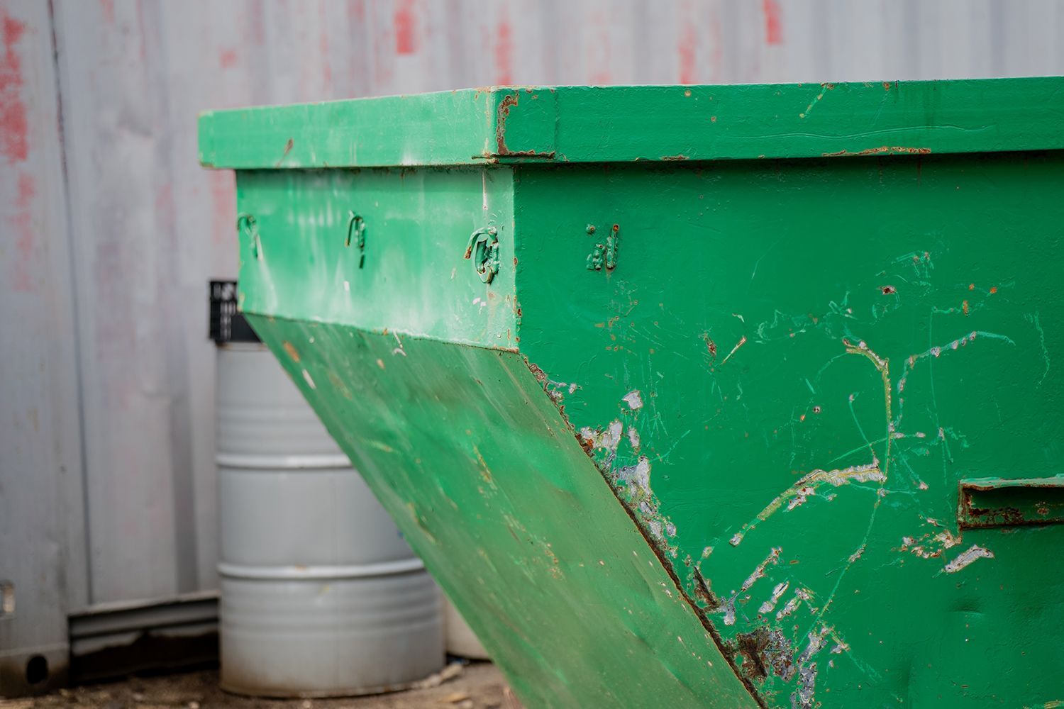 Large green dumpster showcasing roll off dumpster rental for demolition and construction debris.