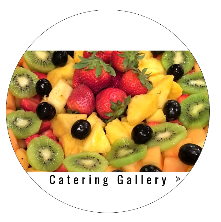 Fruit catering platter with strawberries, kiwi, pineapple, and black grapes, labeled “Catering Gallery”