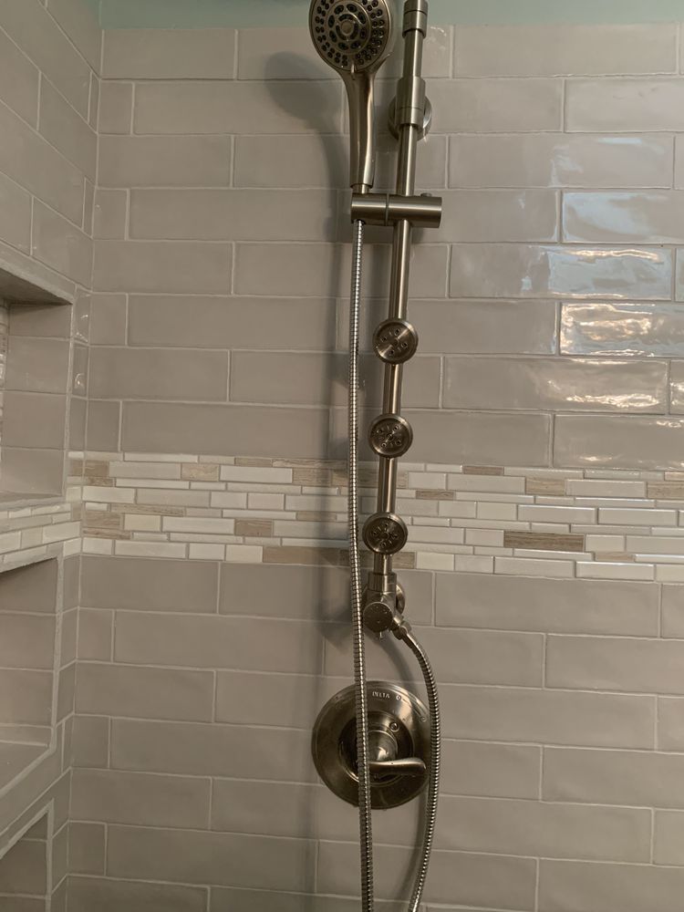 a shower head with a hose attached to it in a bathroom .