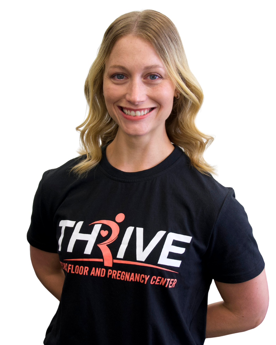 Smiling person wearing a black THRIVE T-shirt with hands behind their back on a white background